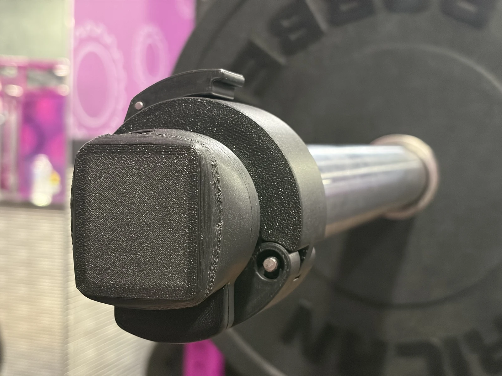 Veiss sensor clamped to a loaded barbell